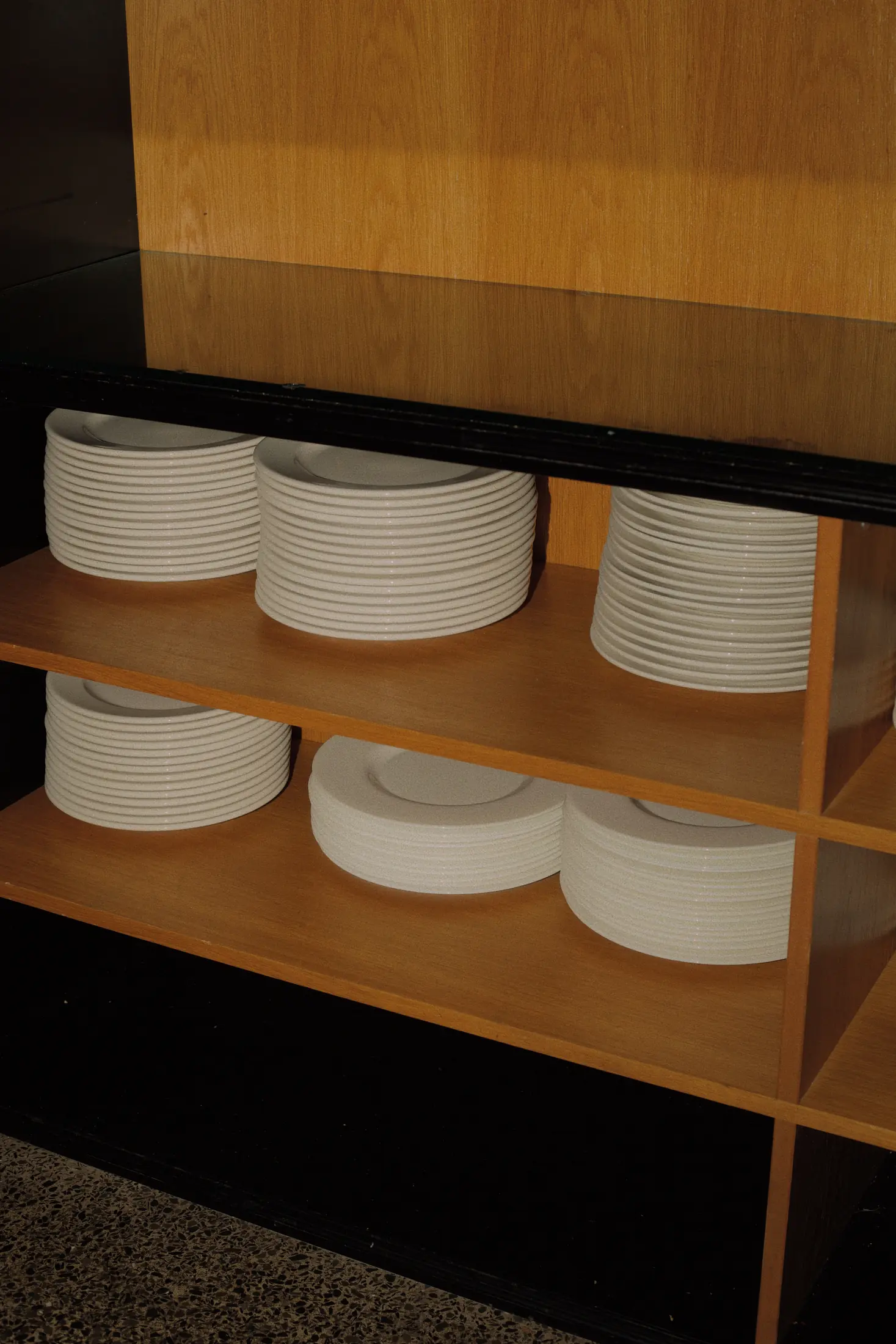 Ceramic plates on wooden shelves