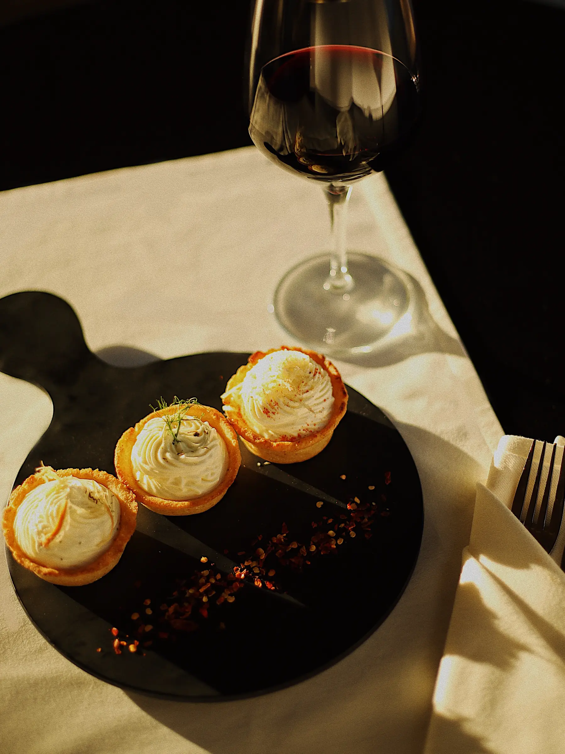Dessert and wine in hard evening light